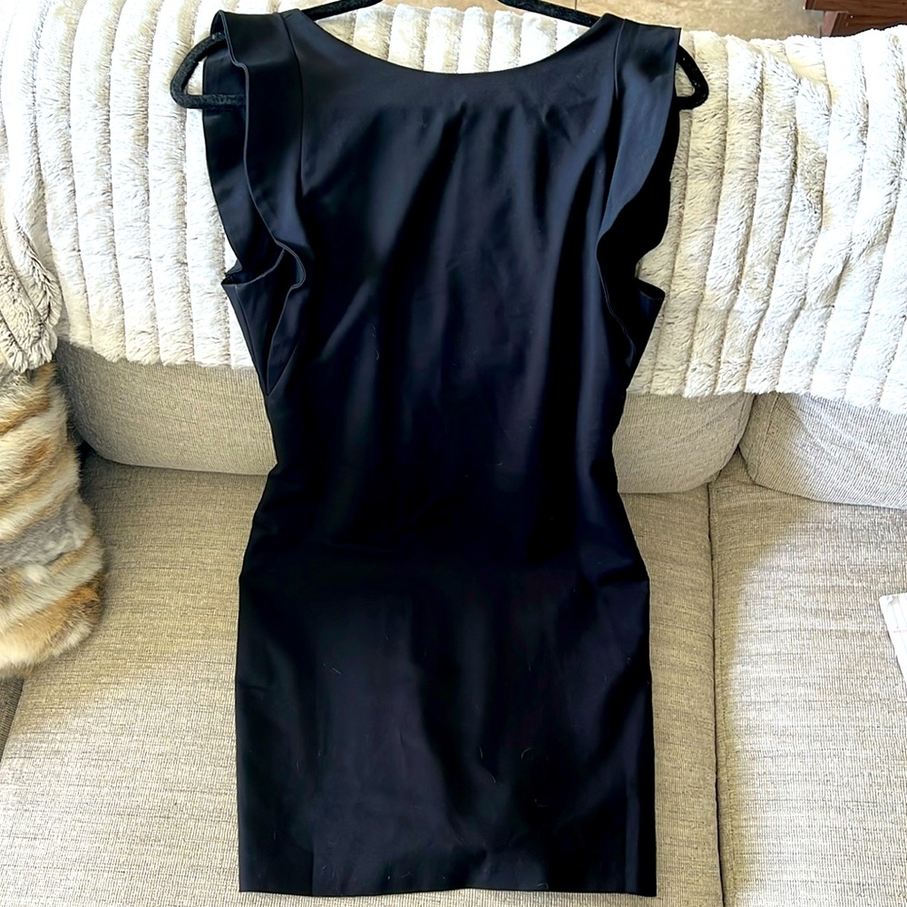 Black fitted dress falls above the knee